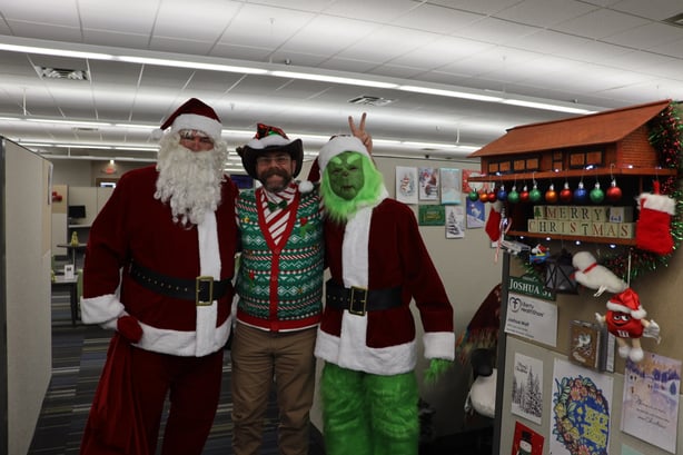 Wolf celebrating Christmas at the office with santa and the grinch