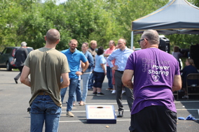 employees playing cornhole