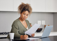 woman looking at paperwork for Christian healthshare