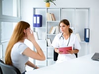 woman asking her doctor questions about a health issue