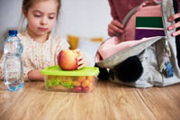 child with healthy snacks which are one of the back to school tips for parents 2023