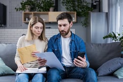 a family reviewing medical bills knowing their hospital charges can be paid in part by a health shar…