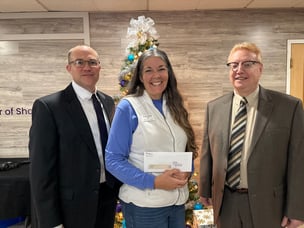 Liberty HealthShare delivers a check to Canton, Ohio's Refuge of Hope to fight food insecurity.