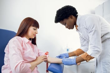 Doctor explaining blood testing to a patient and how these screening tests cover blood work which measure liver function