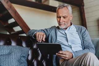  man reading about the heart healthy diet in relation to mitigating heart attack risk factors like high blood pressure