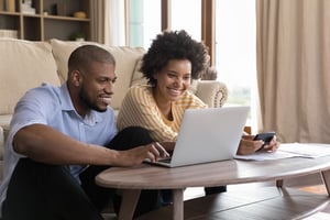 a father and teenage daughter look over her finances to learn financial literacy and economic education to provide a solid financial education