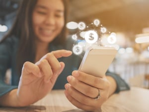 a teenager looking over her personal finance on her smart phone using next gen personal finance and credit report app