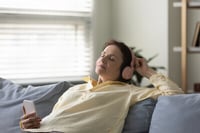 woman trying a christian meditation app on her phone after reading about Christian mindfulness in an article about meditation and mindfulness apps