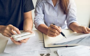 a man and woman going over medical bills