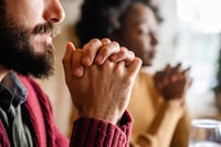 a couple in prayer of encouragement for a friend