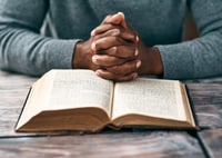 man with bible reading scripture for business owners