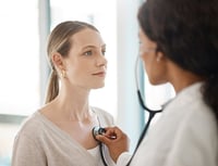 woman getting a checkup with doctor for heart disease