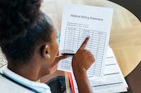 woman looking at a hospital bill