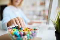 woman reaching for sugary candy