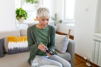 woman testing blood sugar for diabetes